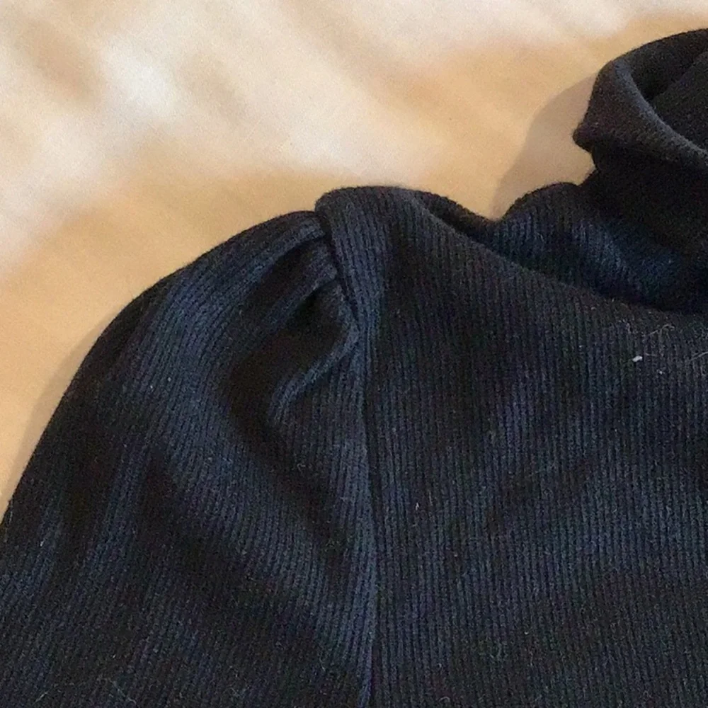 GAP - a long-sleeved, ribbed knit top notable for its puff shoulders.
